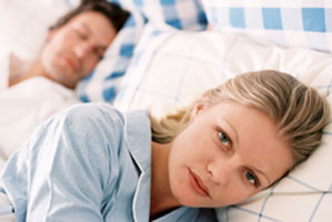 Frustrated woman can't sleep next to snoring man