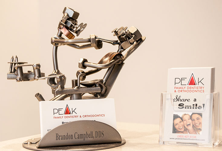 Office business cards in metal dentist and patient sculpture